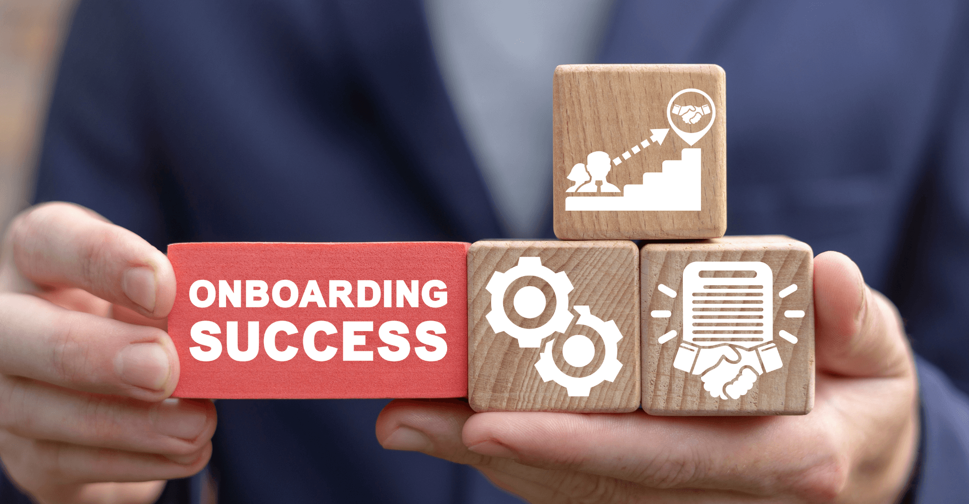 An image of a man holding blocks that say onboarding success.